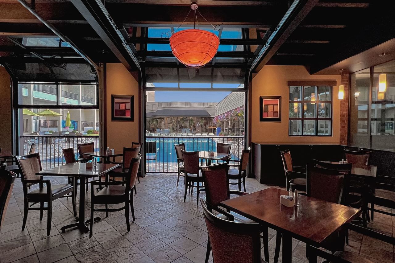 Indoor restaurant with patio doors open to pool