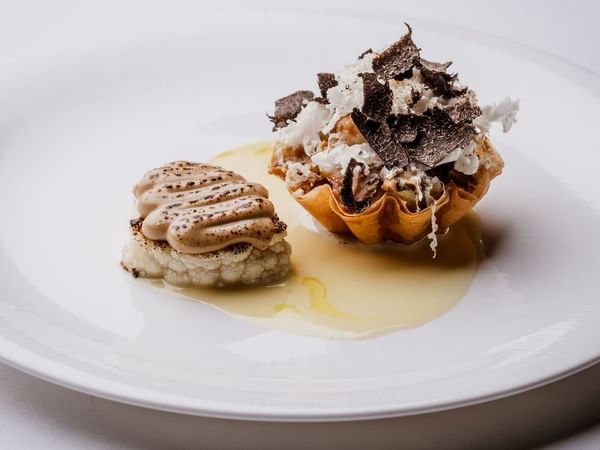 Elegant dessert presentation on a white plate at The Capital Hotel, Apartments & Townhouse.