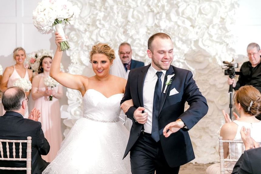 A couple dances down the aisle after getting married at our Avalon, NJ, wedding venue