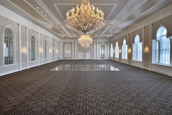 empty ballroom with a large golden chandelier