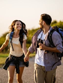 Couple strolling on a mountain trail at sunrise near Cove Pocono Resorts