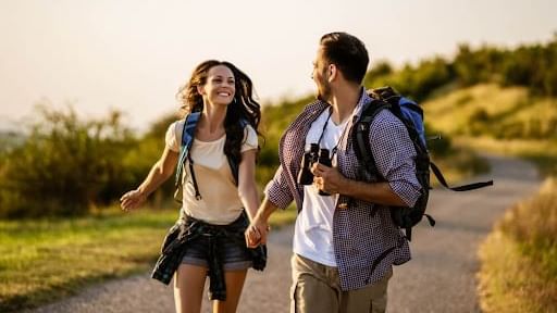 Couple strolling on a mountain trail at sunrise near Cove Pocono Resorts