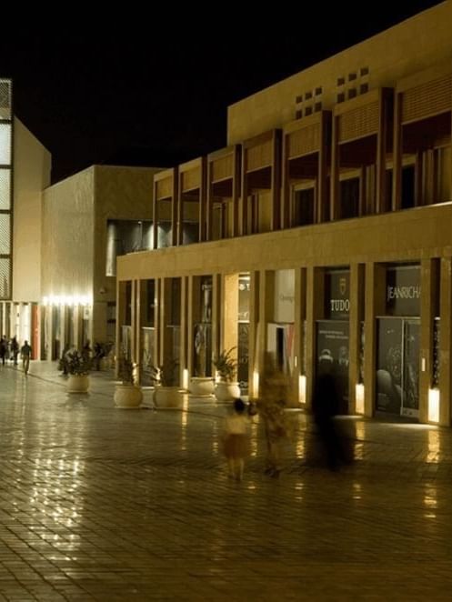View of the Beirut Souks with lighted stalls by white pillars under a dark sky near Warwick Stone 55 - Beirut