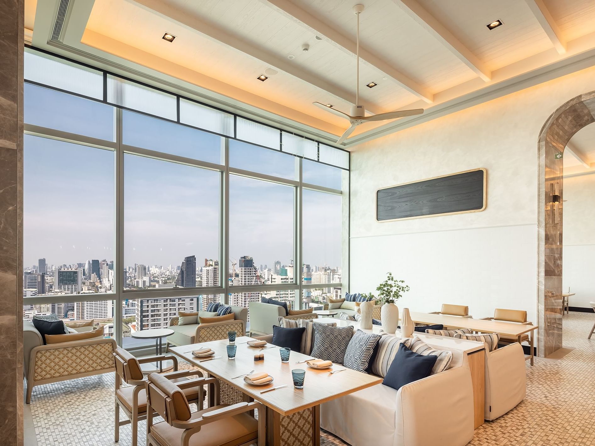 Restaurant-style dining set-up in Trattoria@22 with a city view at Eastin Grand Hotel Phayathai