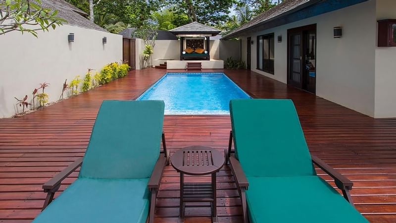Sunbeds on a deck in Pacific Pool Villa at Warwick Le Lagon 