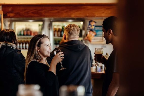 People enjoying drinks in the Hamer’s Bar & Bistro at Strahan Village