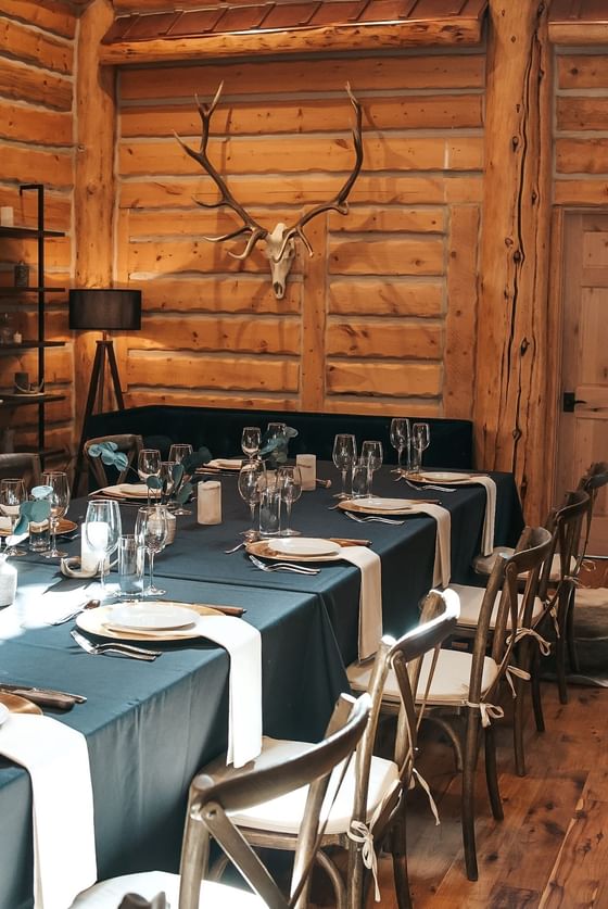 Dining table arranged for an event with a wooden interior at Hotel Jackson