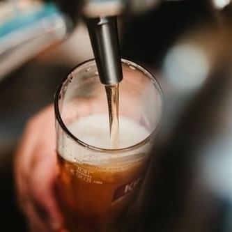 Close-up of pouring beer tap at a brewery near La Galerie Hotel