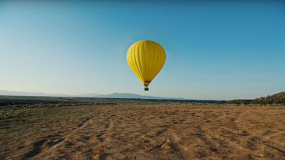 Hot air balloon flying over the wide plains near Don Fernando