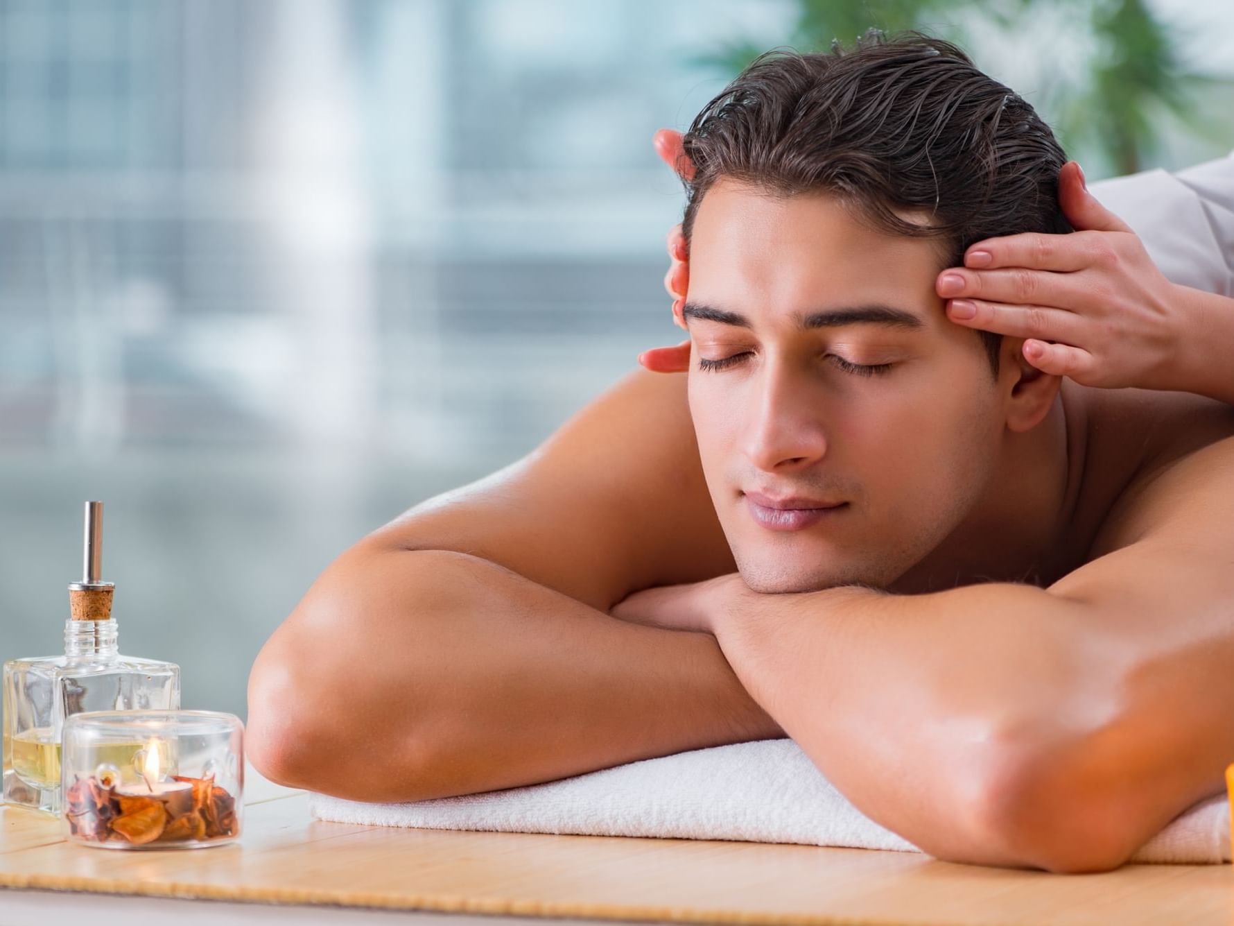 Man getting a massage at a City Seasons Hotel