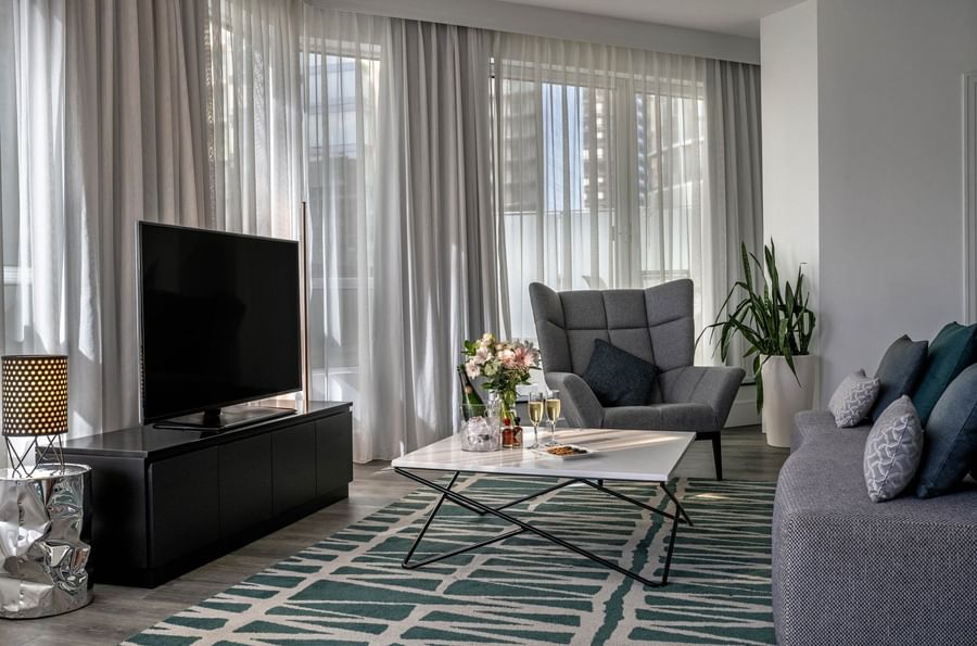 TV lounge with plush sofa near window in Penthouse de la Montagne at Warwick Le Crystal Montreal