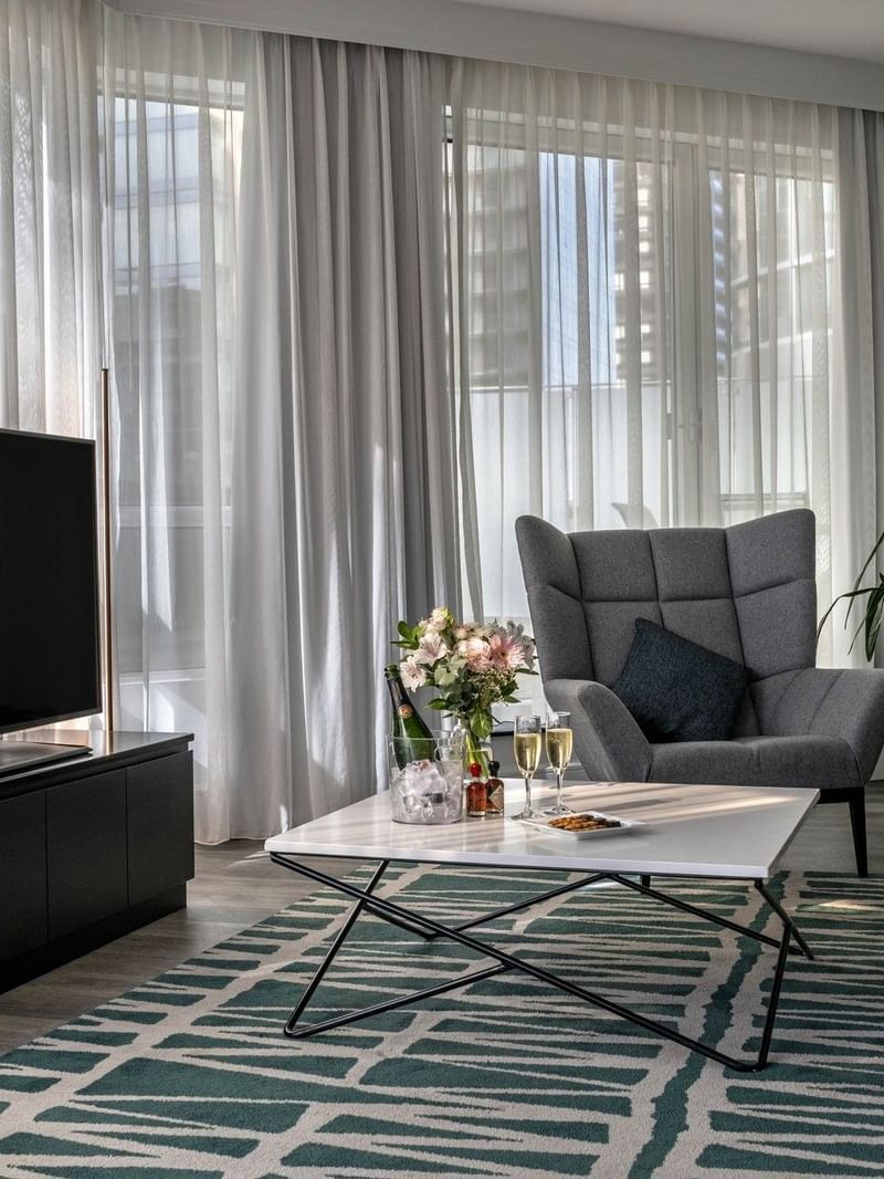 Stylish living room with modern furniture and flat screen TV at Warwick Le Crystal – Montreal.