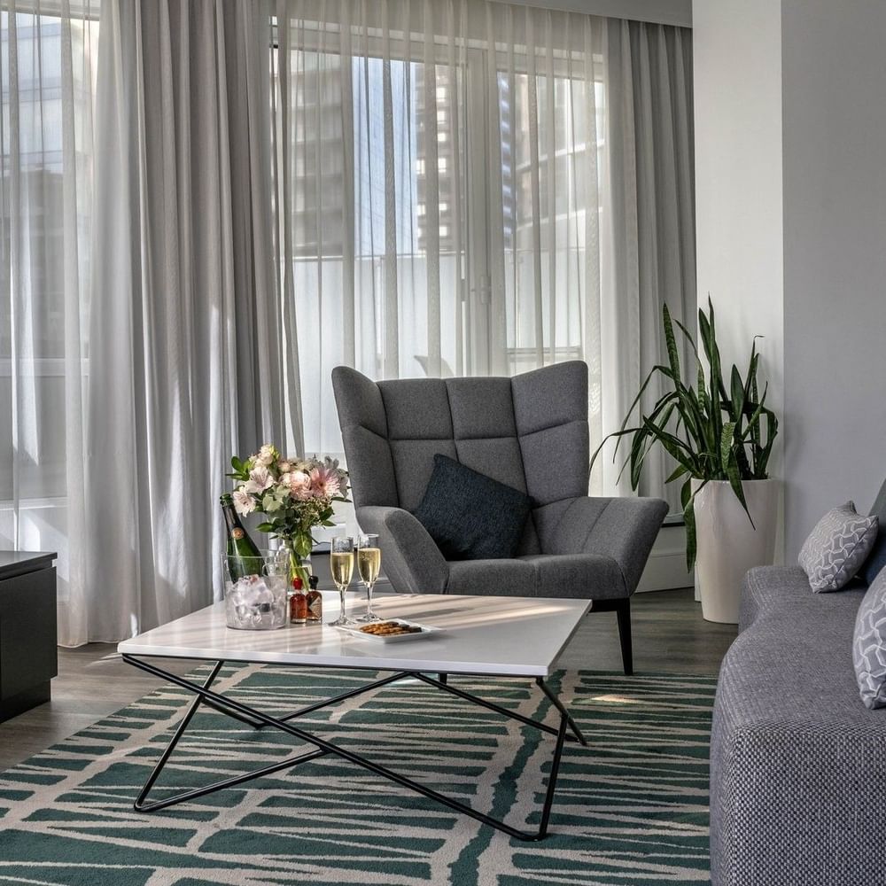 TV lounge with plush sofa near window in Penthouse de la Montagne at Warwick Le Crystal Montreal