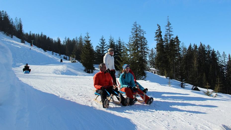 People tobogganing near Hotel Liebes Rot Flueh