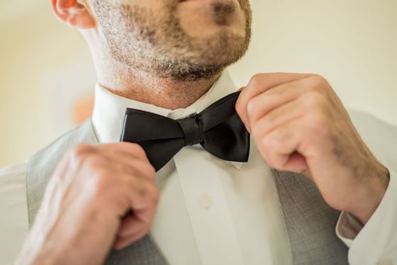 Groom touching his bow at The Imperial Hotel Blackpool