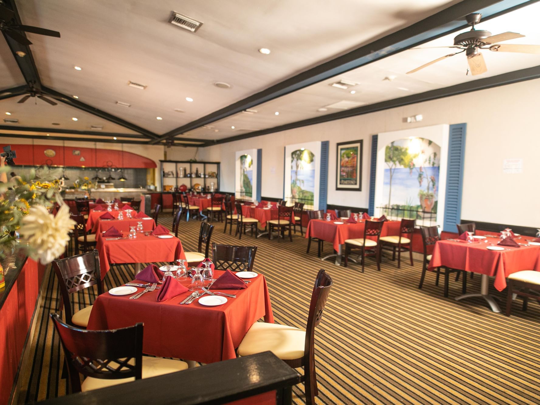 Dining tables with carpeted floors in Sorrento Italian at Holiday Inn Montego Bay