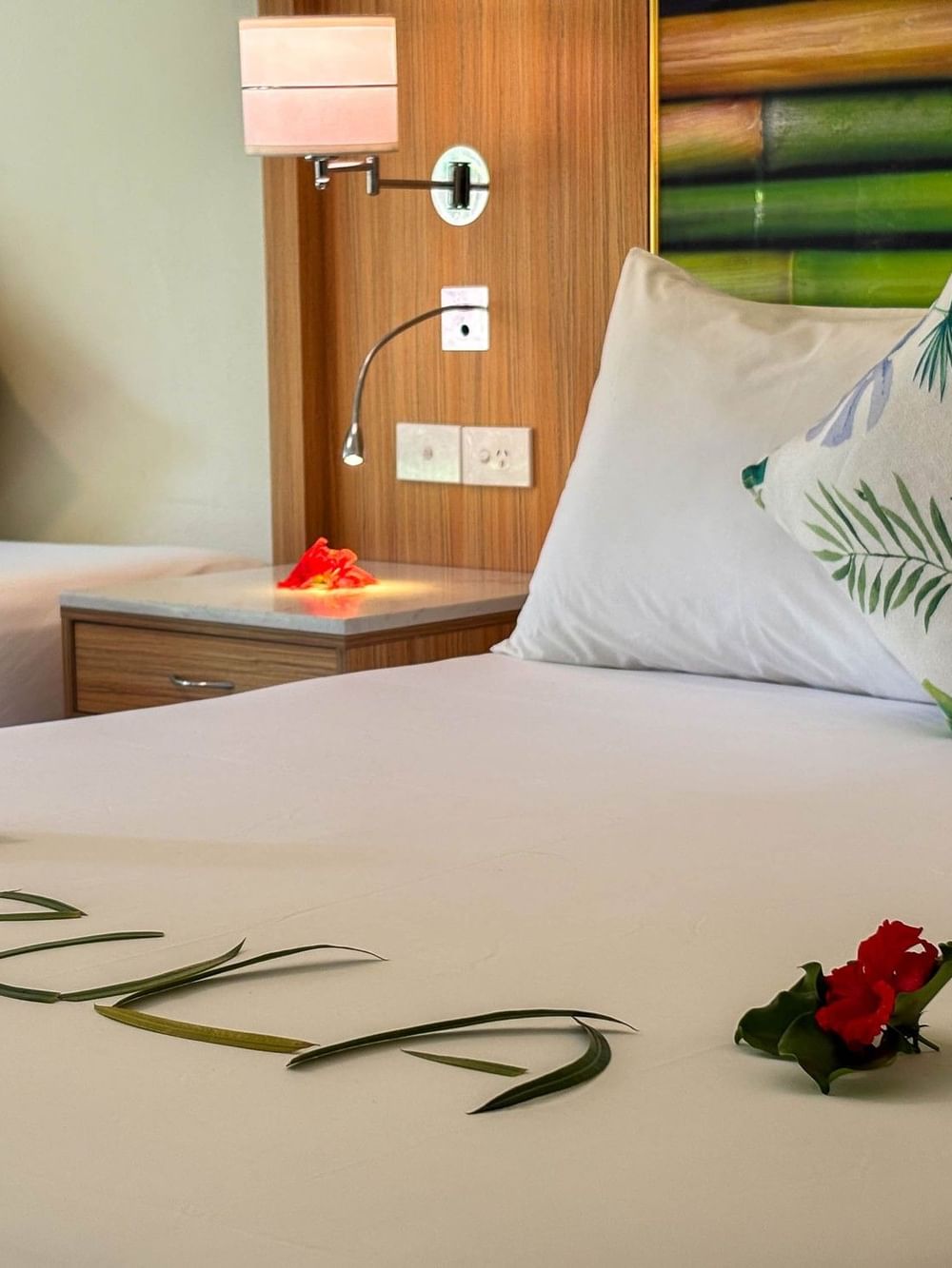 Superior Garden View Room with tropical decor and floral arrangements at The Naviti Resort in Korolevu.