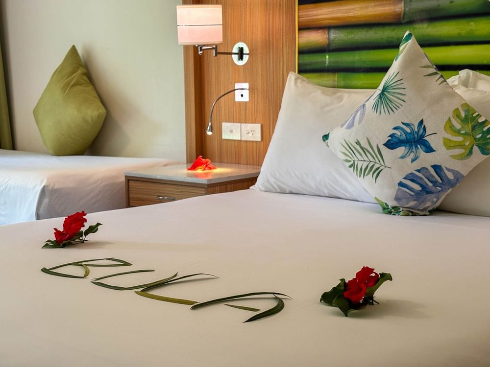 Superior Garden View Room with tropical decor and floral arrangements at The Naviti Resort in Korolevu.