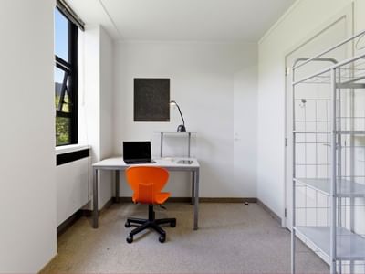 Empty room with desk, chair, and storage at UniLodge Stafford House.
