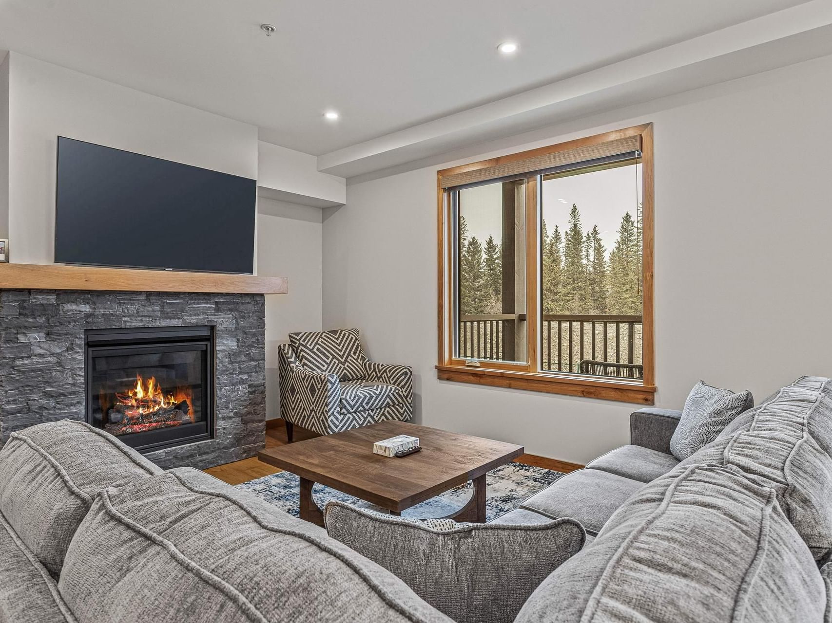 110 Timberstone Lodge Three Bedroom Premier Condo living area with a fireplace, and sofa at Spring Creek Vacations