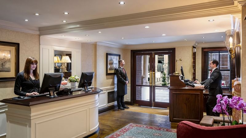 Reception and Concierge Desk with people at The Capital Hotel