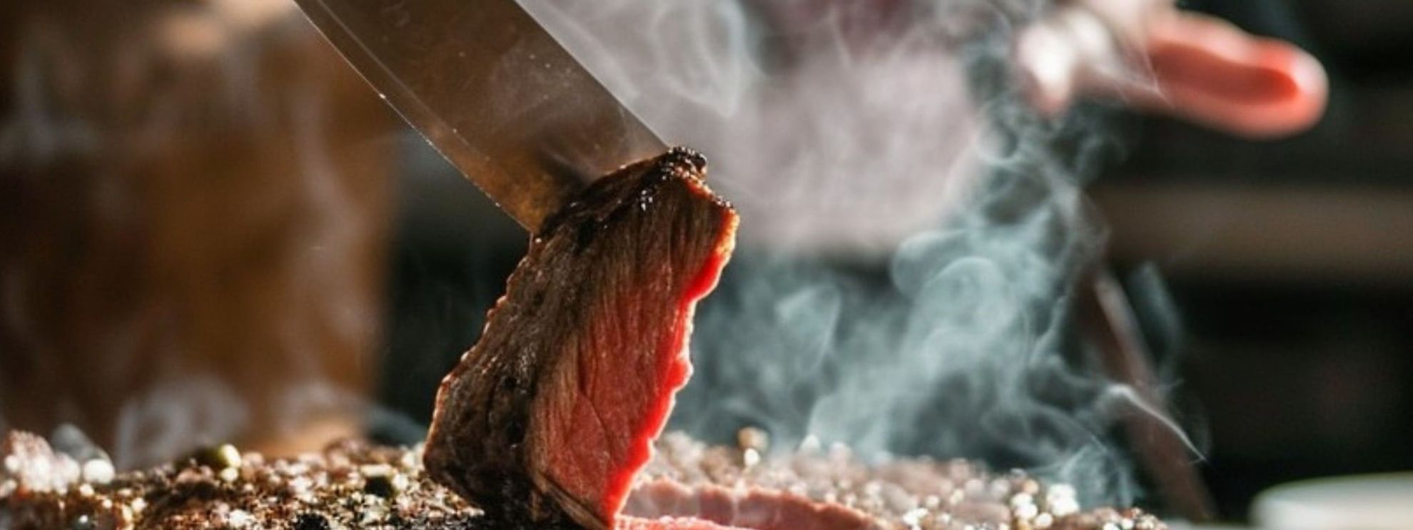 Chef cooking spit on terrace