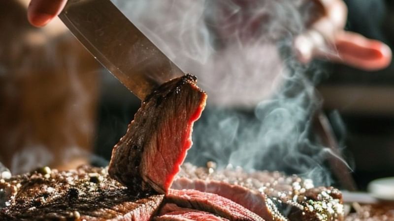 Chef cooking spit on terrace
