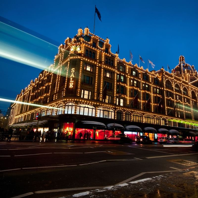 Harrods building in London near Capital Hotel during night time