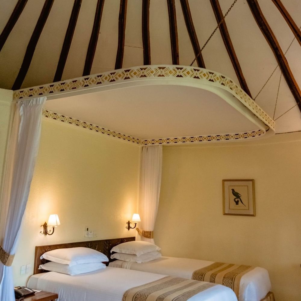 Two beds in a Standard Triple Room at Arusha Serena Hotel in Arusha.