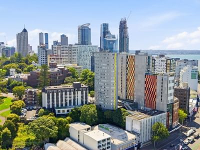 City skyline and urban landscape with modern buildings and greenery at Student Living Auckland - Beach.