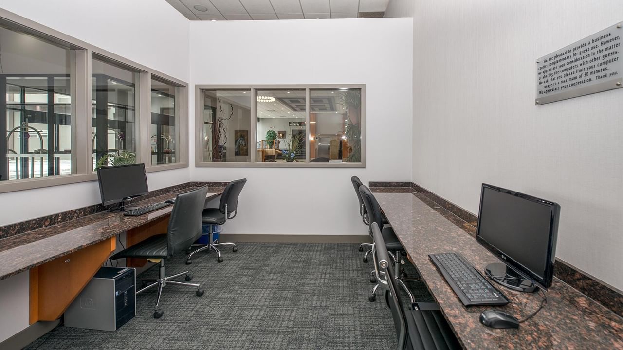 Business center with desks, computers, and chairs.