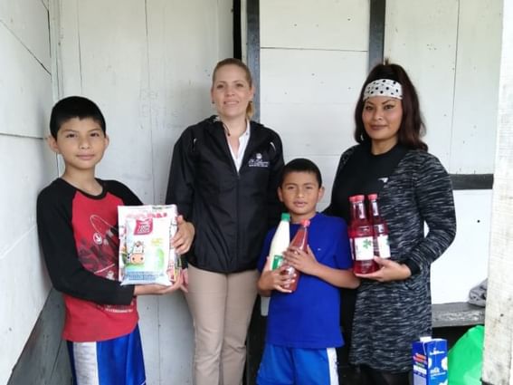 kids and adults posing for picture with food product