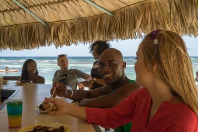 A group of people in a Jerk hut at Holiday Inn Montego Bay