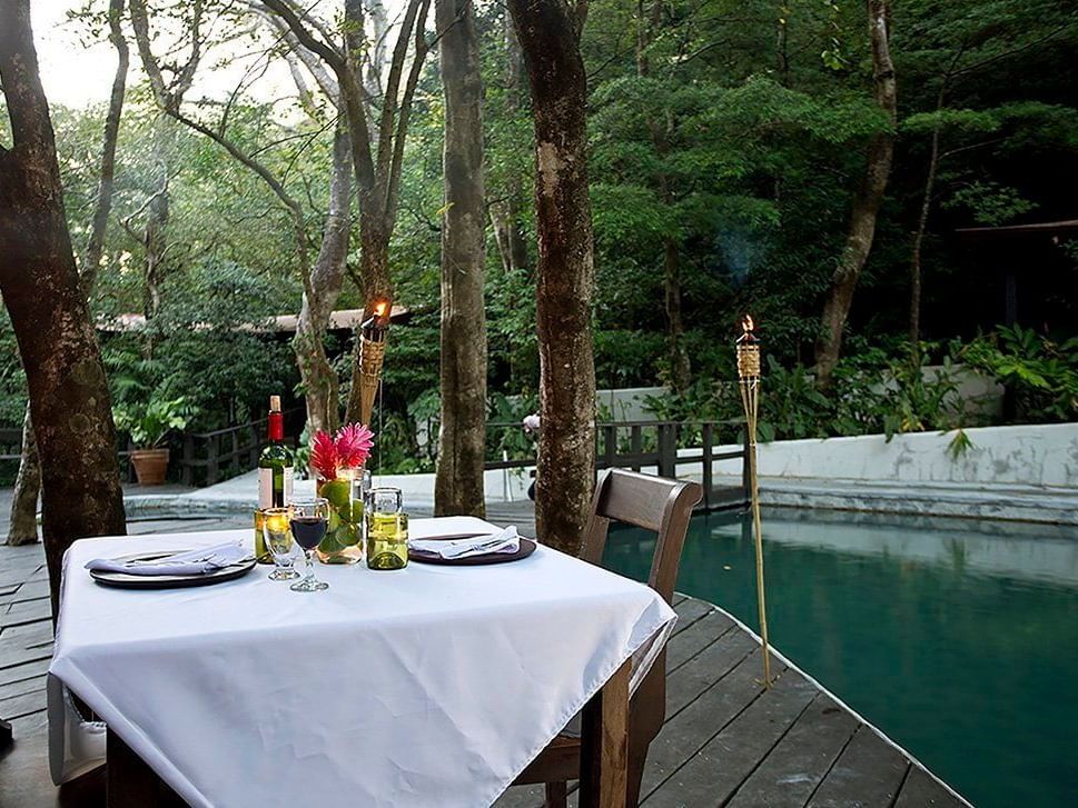 Dining table arranged by the pool at Buena Vista Del Rincon