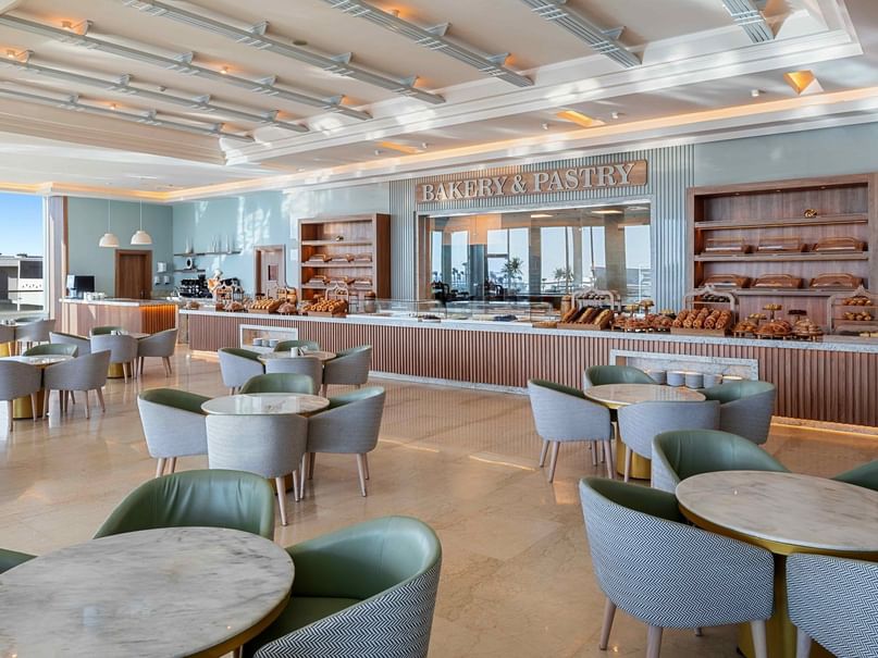 Bright bakery station with display shelves and seating area at Pickalbatros Royal Moderna Resort - Sharm El Sheikh.