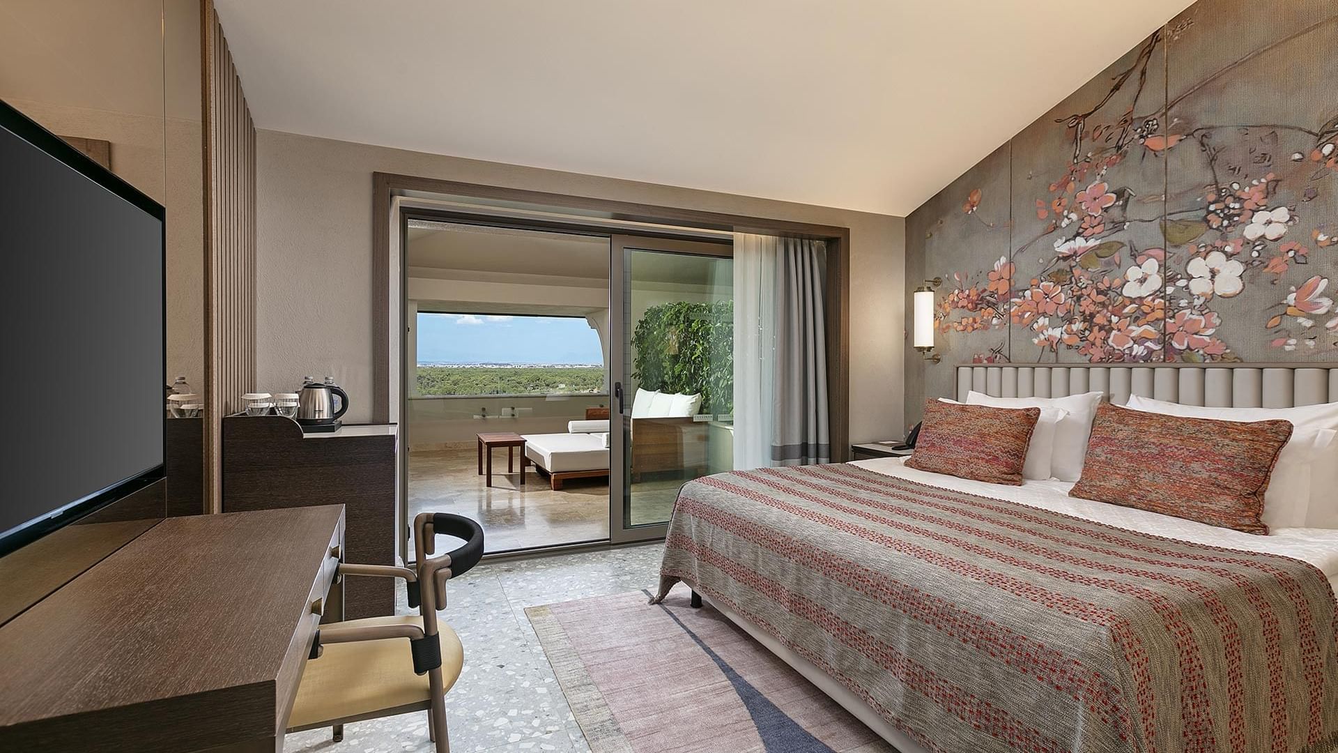 TV facing the bed in Roof Superior Room with floral wall art at Cullinan Belek