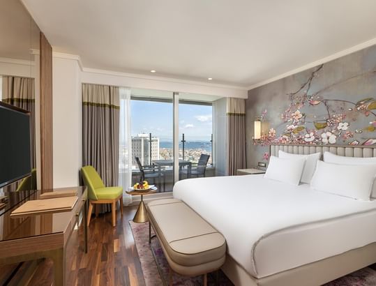 Titanic Port Bakırköy'de, Büyük bir yatağa, balkona ve cam kapılardan şehir manzarasına sahip lüks Executive oda.