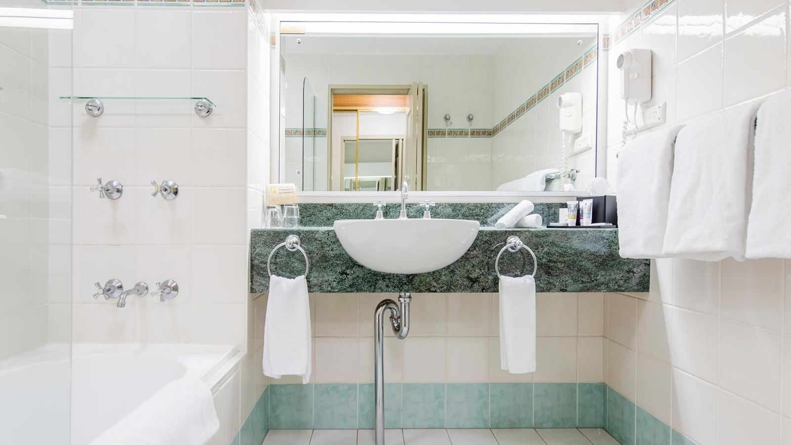 Marbled vanity area by the bathtub in Standard Twin Room bathroom at Mercure Charlestown