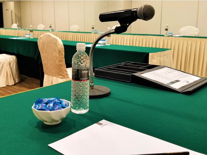 Image 127: Conference room setup with microphones on a table with flowers at Sunway Hotel Georgetown