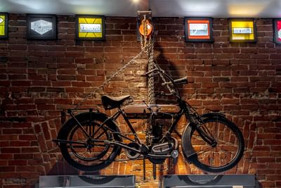 Vintage motorbike hung on a metal chain in Queen Premiere Easy Rider at Retro Suites Hotel
