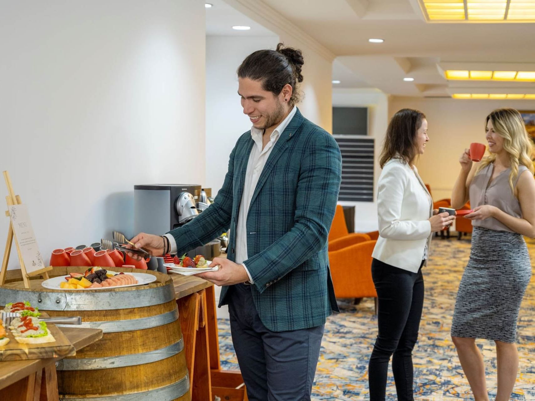 People self-serving refreshments from the function catering station at Grand Chancellor Adelaide