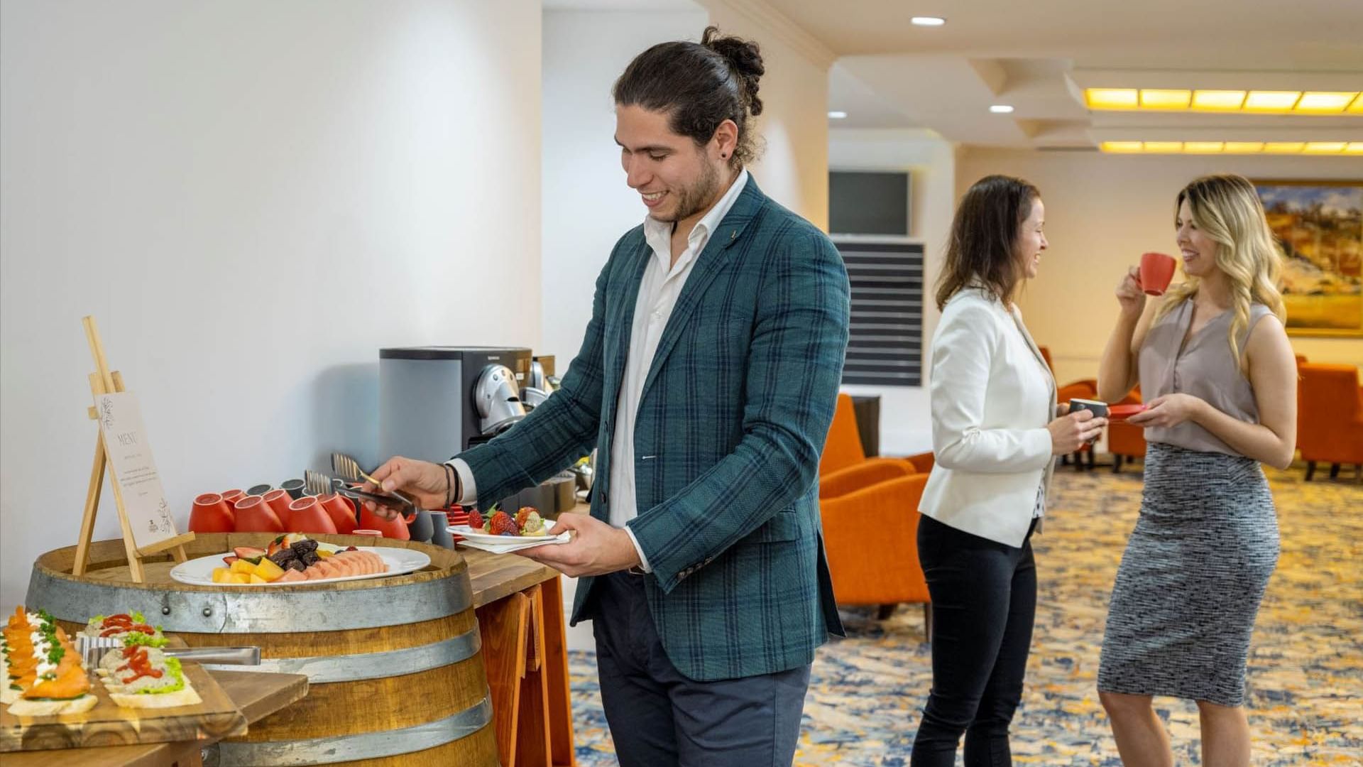 People self-serving refreshments from the function catering station at Grand Chancellor Adelaide