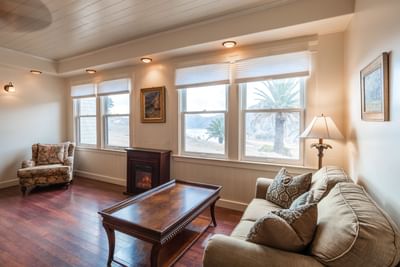Sofa chair with hearth and interior of Carraige House at Banning House Lodge