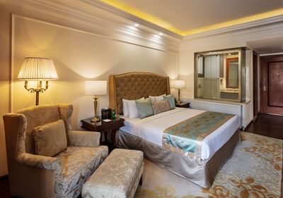 TV stand facing the king bed & sitting area in Premiere Room at The Indus Valley Leh, Hotel Stay in Leh