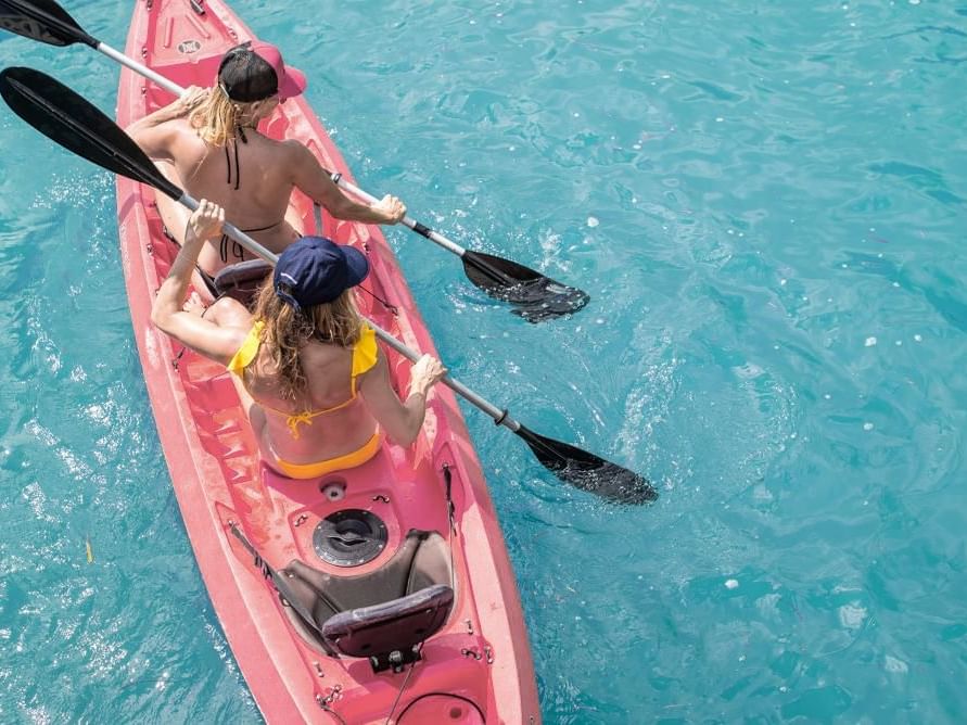 Top view of 2 girls kayaking on the sea near South Beach Hotel