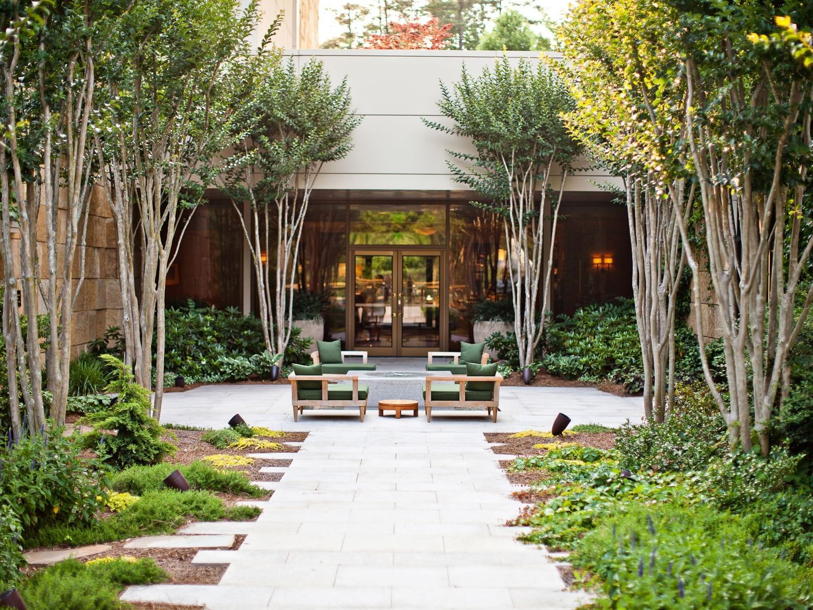 Outdoor lounge area surrounded by lush greenery at The Umstead Hotel and Spa