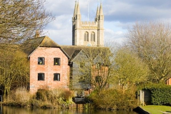 A scenic view of Newbury in Berkshire, featuring historic buildings, greenery and the surrounding townscape.