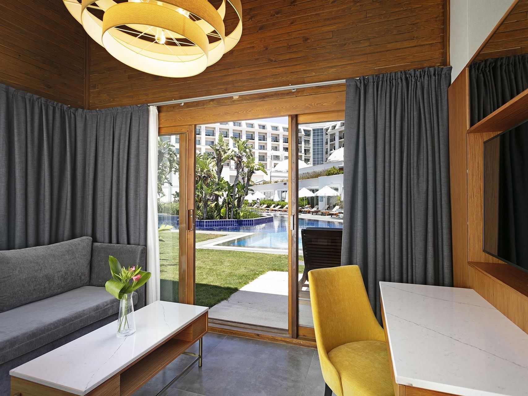 Lounge area with TV and working table in Bali House Garden at Titanic Deluxe Golf Belek