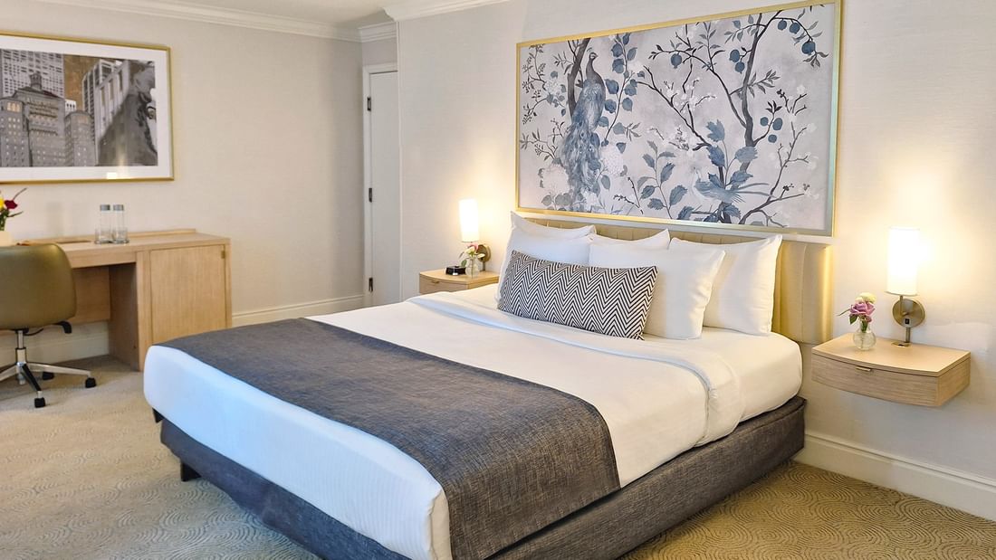 Bed with side tables near work desk in Accessible King Room at Warwick Allerton Chicago