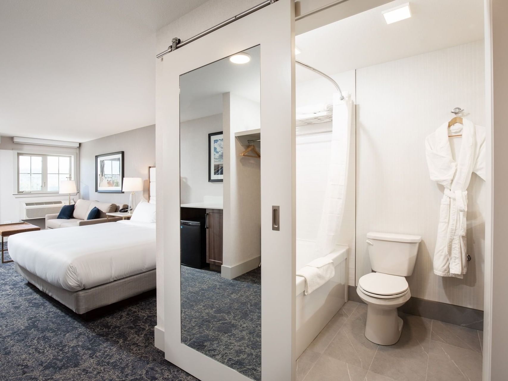 a bed and bathroom in a hotel room